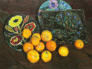 Апельсины на фоне керамики